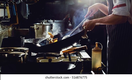 Chef is stirring vegetables  in wok on street food concept - Powered by Shutterstock