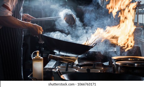 Chef is stirring vegetables in wok, vintage filter - Shutterstock ID 1066763171