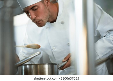 Chef tasting food in restaurant kitchen - Powered by Shutterstock