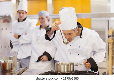 Chef tasting his students work in kitchen - Powered by Shutterstock