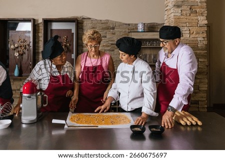 Chef teaching students how to prepare food in cooking class