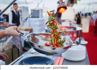 Chef Tossing Vegetables In A Wok