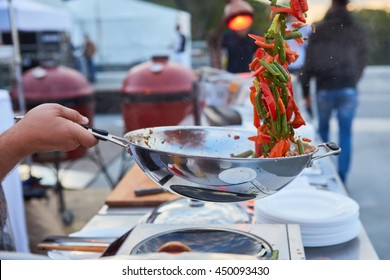 Chef Tossing Vegetables In A Wok