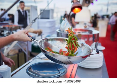 Chef Tossing Vegetables In A Wok