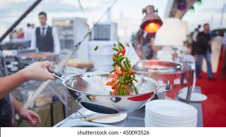 Chef Tossing Vegetables In A Wok