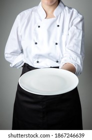 chef uniform with white empty plate welcome present dish restaurant promotion