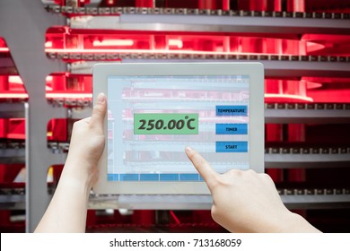 Chef use tablet to control temperature on modern gas oven to cooking food, Business owner with modern technology concept for restaurant.