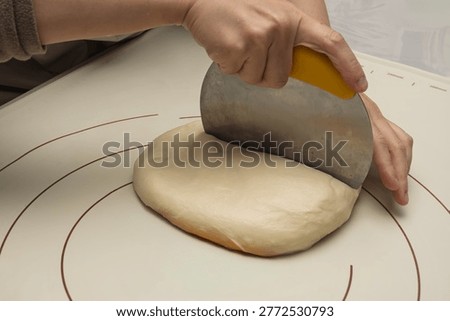 Chef Uses Scraper To Divide Bread Dough