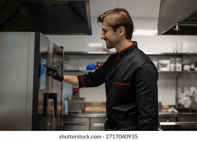 Chef using touchscreen control panel on modern smart oven in kitchen