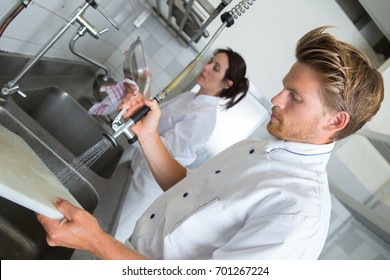 Chef washing chopping board - Powered by Shutterstock