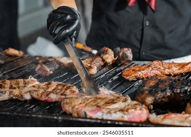 Chef wearing red bandana, grilling steaks over open flame on barbecue, carefully cooking meat to perfection - Powered by Shutterstock