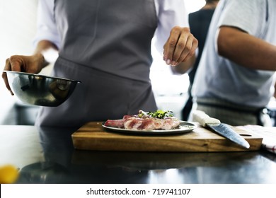 Chef Working And Cooking In The Kitchen