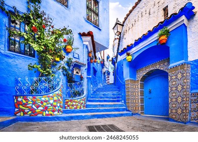 Chefchaouen, Morocco. Blue staircase and wall decorated with colorful flowerpots, North Africa travel destination. - Powered by Shutterstock