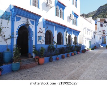 CHEFCHAOUEN, MOROCCO on APRIL 2019: Frontage of moroccan alley in african city, clear blue sky in warm sunny spring day.