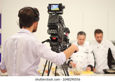 Chefs Cooking On Television Show Cameraman In Focus 