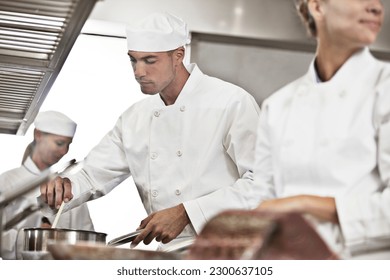 Chefs cooking in restaurant kitchen - Powered by Shutterstock