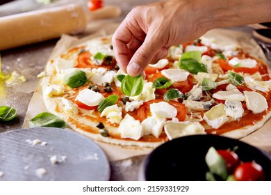 Chefs hands preparing making pizza at kitchen. fresh home recepie. mozzarella ,basil ,tomatoe ,gorgonzola - Powered by Shutterstock