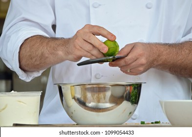 Chef's Hands Zesting A Lime, Reflection In The Bowl Of Cutting Board And Food At A Chef Demonstration