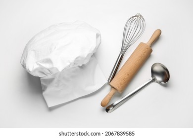 Chef's Hat And Kitchen Utensils On White Background