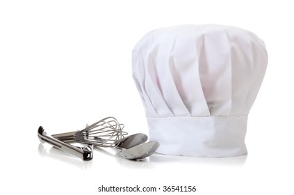 A Chefs Hat And Utensils On A White Background