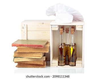 Chef's Hat, Vintage Cookbooks, And Bottles Of Aromatized Olive Oil Isolated On A White Background.