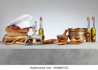 Chef's Hat, Vintage Cookbooks, And Old Kitchen Utensils On The Kitchen Table. Copy Space.