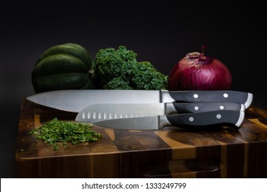 Chef's knife, knives, cutting board and vegetables