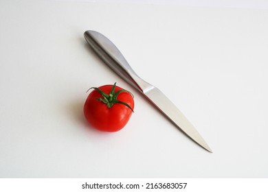 Chef's Knife And Tomato Isolated.