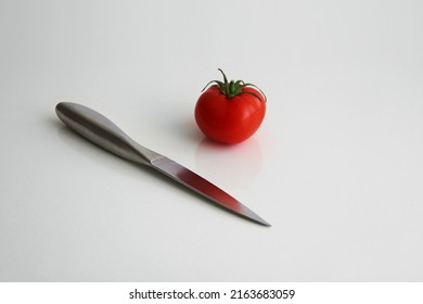 Chef's Knife And Tomato Isolated.