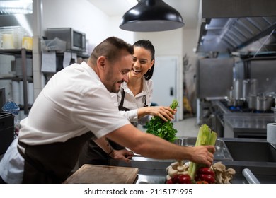 Chefs preparing vegetables for cutting in commercial kitchen. - Powered by Shutterstock