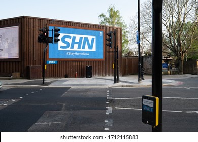 Chelsea, London / UK - April 23 2020: SHN, Stay Home Now. NHS Logo Shown Upside Down On Billboard On Empty Streets In Advertising Campaign To Promote Quarantine During Covid-19 Coronavirus Pandemic