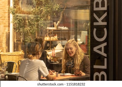 CHELSEA MARKET, NEW YORK CITY, USA - 14 MAY 2018: Market food in Chelsea neighborhood district Manhattan NYC, people eating in cafe restaurant