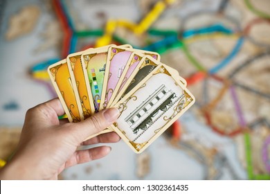 Chelyabinsk, Russia - February 1, 2019: Hand Hold Cards Of Ticket To Ride Game. It Is A Railway-themed German-style Board Game.