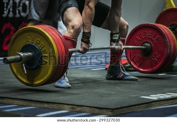 Chelyabinsk, Russia - July 17, 2015: powerlifter\
athlete getting ready exercises deadlift during National\
championship powerlifting, bench press and\
deadlift