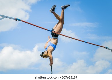 Chelyabinsk, Russia - July 24, 2015:  young woman athlete jumping with a pole overcomes bar during National competitions in memory of G. I. Nicewhen athletics - Shutterstock ID 307685189