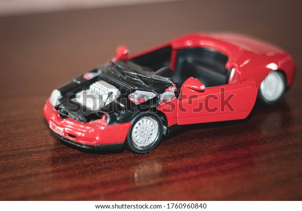 Chelyabinsk,
Russia-June 15, 2020:A broken toy car for repair model on a table
in the dust. Old toy. Selective
shot.