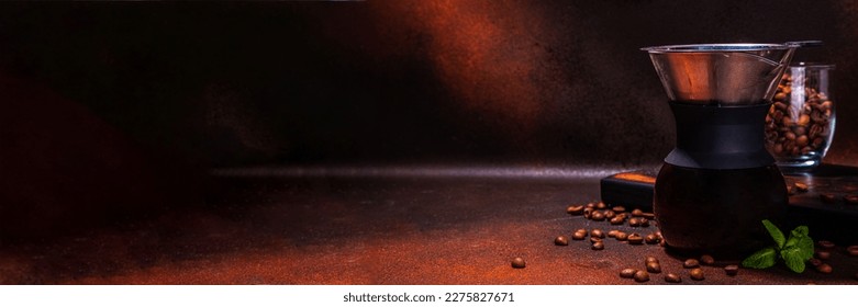 Chemex handy brew coffee maker, slow and drip brew espresso coffee making device, with coffee beans on dark brown background copy space - Shutterstock ID 2275827671