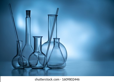 Chemical dishes on a gray background. Equipment of laboratories. Chemical concept. Different types of tests. Experiments. Testing of product samples. Sale of chemical equipment. - Powered by Shutterstock