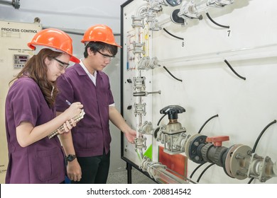 Chemical Engineer Student Checking Equipment In Control Room For Training