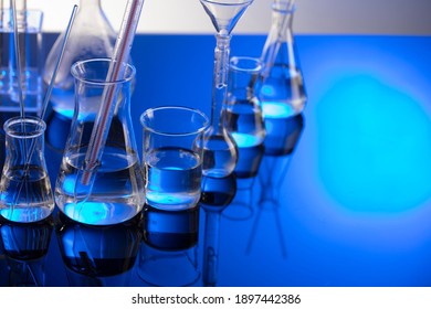 Chemical experiment concept. Laboratory equipment. Blue background.