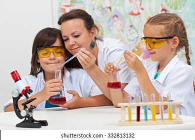 Chemical Experiments In Elementary School - Kids Helped By Teacher In Science Class