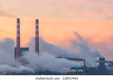 Chemical Factory In The Morning, With Pipes And Polluting Smoke, Long Exposure