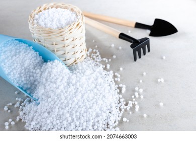 Chemical fertilizers Urea are in wooden baskets with plants placed on a white background. Concept fertilizers N, P, K, Ca, Mg, S, Mn, Cl, B, Fe, Zn - Shutterstock ID 2074663003