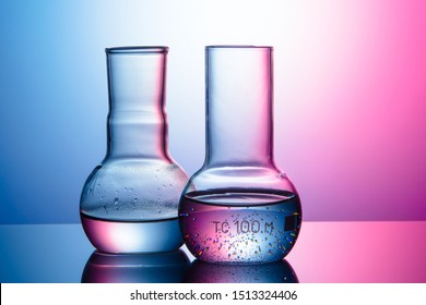 chemical flasks with water, with gradients of warm and cold colors.Thermodynamic concept.
