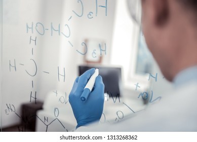 Chemical Formula. The Hand Of Scientist Writing A Formula On The Glass Wall