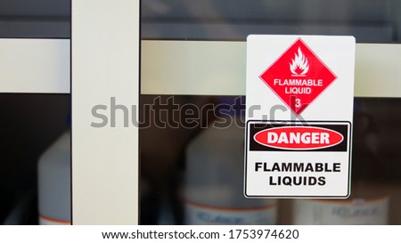 Chemical hazard sign pictogram, Globally Harmonized System of Classification and Labelling of Chemicals (GHS). Flammable liquid danger warning caution sticker with container bottle in storage cabinet.