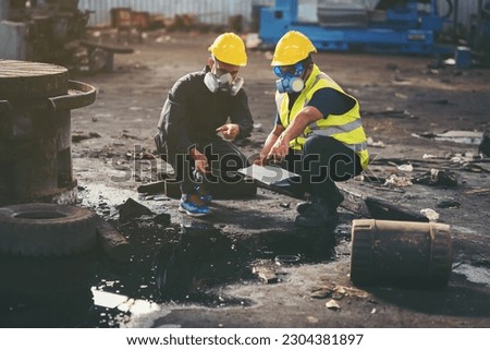 Chemical leak and safety first concept. Group of chemical specialist wear safety uniform, gas mask inspecting chemical leak in industry factory. Two scientists checking quality of liquid in plant