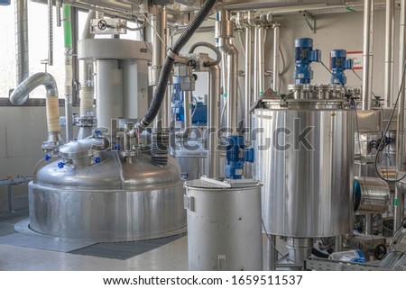 a chemical production plant with various agitators made of stainless steel