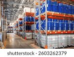 Chemical products warehouse. Barrels of petroleum on multi-tiered racks. Chemical factory storage area. Modern warehouse inside hangar. Spacious storage with metal and plastic barrels