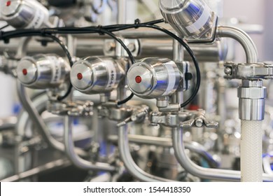 Chemical reactor. Clean pharmaceutical equipment, lots of sparkling chrome plumbing. Modern equipment for the production of drugs.